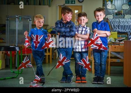 Pictured are pupils from Waunarlwydd Primary School in Swansea, dressed-up to celebrate the Coronation of His Majesty The King on Saturday as members of the public across the UK get ready for the historical event which will see the crowning of King Charles. Pupils at the school were given the chance to wear red, white and blue for their school uniform and took part in coronation events through-out the day. Stock Photo