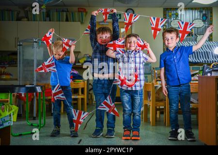 Pictured are pupils from Waunarlwydd Primary School in Swansea, dressed-up to celebrate the Coronation of His Majesty The King on Saturday as members of the public across the UK get ready for the historical event which will see the crowning of King Charles. Pupils at the school were given the chance to wear red, white and blue for their school uniform and took part in coronation events through-out the day. Stock Photo