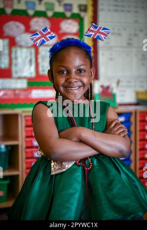 Pictured is a pupil from Waunarlwydd Primary School in Swansea, dressed-up to celebrate the Coronation of His Majesty The King on Saturday as members of the public across the UK get ready for the historical event which will see the crowning of King Charles. Pupils at the school were given the chance to wear red, white and blue for their school uniform and took part in coronation events through-out the day. Stock Photo