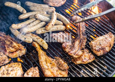 Barbecue in the garden, steaks and sausages on a grill, Stuttgart, Baden-Wuerttemberg, Germany Stock Photo