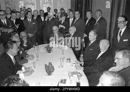 'On 28.02.1967, former Chancellor Konrad Adenauer came to Munich for the premiere of the film '' 90 Years of German History - 90 Years of Konrad Adenauer '' by the Munich Insel-Filmgesellschaft. Reception during Adenauer's visit to Munich. To the right of Adenauer Julius Cardinal Döpfner. Fritz Schäffer is fourth at the left side of the table. Bavarian Prime Minister Alfons Goppel is cut in at the bottom right. [automated translation]' Stock Photo