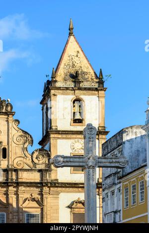 Facade facade of an old historic church with a large crucifix in the central square in Pelourinho, histoic center of Salvador city, Bahia, Brasil Stock Photo