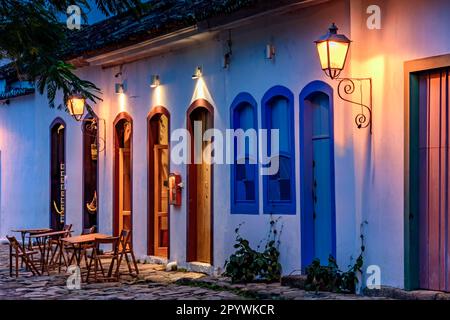 Street and colonial style houses illuminate at night in the city of Paraty on the coast of Rio de Janeiro, Brazil, Brasil Stock Photo