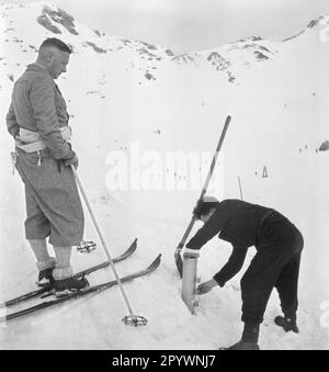 A climatologist sets up a measuring device to measure the thickness of snowpacks. Undated photo. Stock Photo