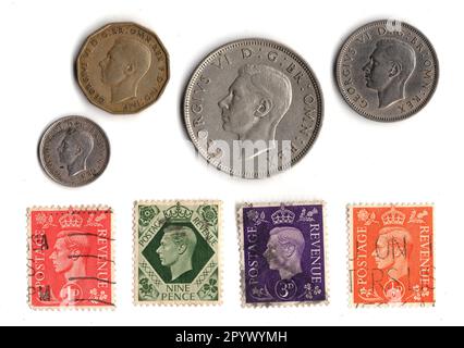 Vintage coins and stamps from the reign of King George VI isolated on a white background. Stock Photo