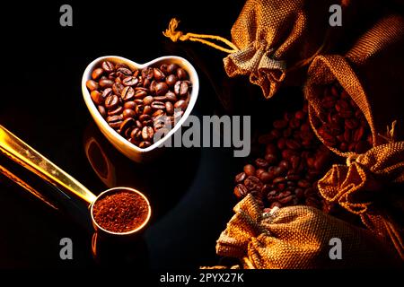 Fresh raw coffee beans isolated on black glass Stock Photo