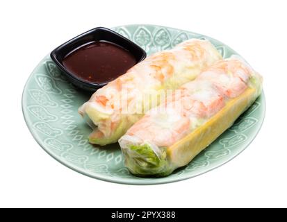 vietnamese Goi Cuon spring rolls with rice noodles, shrimp, chicken and salad wrapped in rice paper on plate cutout on white background Stock Photo