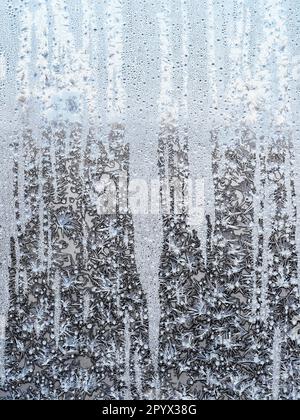freezing surface on home window glass on cold winter day Stock Photo