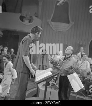 'The picture shows the shooting of the film ''Eva im Frack'' from the year 1951. On the left is Emil Surmann as orchestra leader Frank Witte, at right, director Paul Verhoeven.' Stock Photo