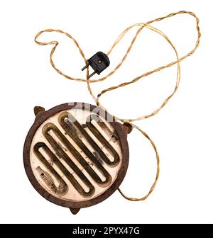 top view of old electric hot plate with open spiral and electric plug cutout on white background Stock Photo