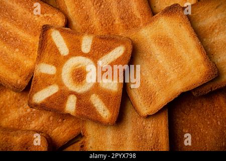 Concept of SPF protection sun sign on toasted bread background. Copy space. Stock Photo