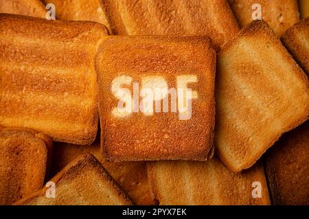 Concept of SPF cream on toasted bread background. Stock Photo