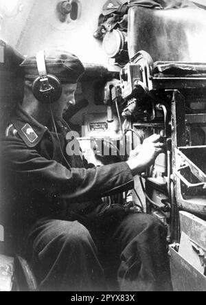 Radio operator working on his radio in a command vehicle at Ssolonenkoje on the Eastern Front. Photo: Springmann [automated translation] Stock Photo