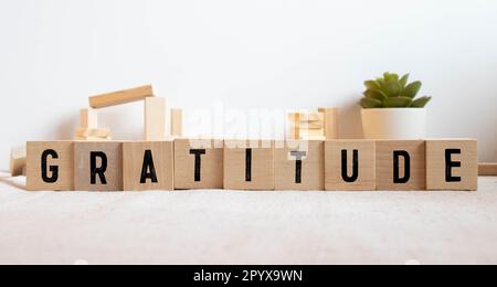 Gratitude - word concept on building blocks. Stock Photo