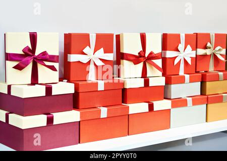 Gift boxes with ribbons on a store shelf Stock Photo