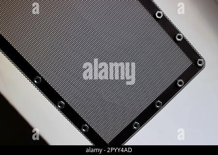 Pattern of protective grill with small round holes and nuts for mounting bracket on the frame isolated on white Stock Photo
