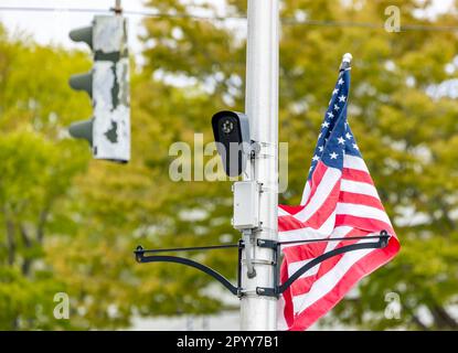Small black surveillance camera monitoring newtown lane in east hampton, NY Stock Photo