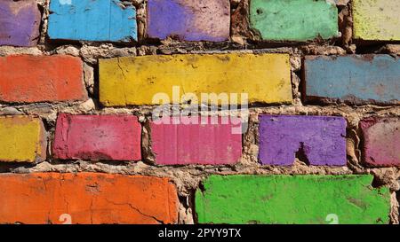 Old brick wall in rainbow colors. Background conceptOld brick wall in rainbow colors. Background concept Stock Photo