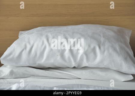 white pillow lined up on bed  Stock Photo