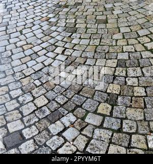 This stock photo features a close-up view of a cobblestone sidewalk texture, highlighting the various shapes and sizes of the stones Stock Photo