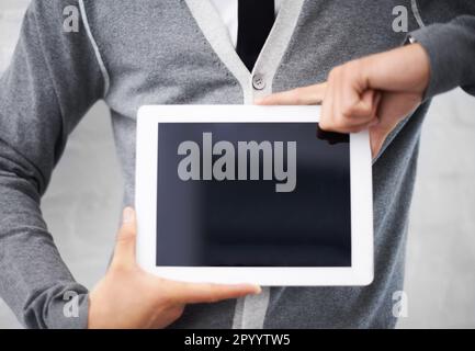 Holding up your message. Cropped image of a nerd holding a digital tablet. Stock Photo