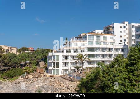 Portocolom, Spain; april 23 2023: Facade of a white tourist hotel in the Majorcan town of Portocolom, Spain Stock Photo