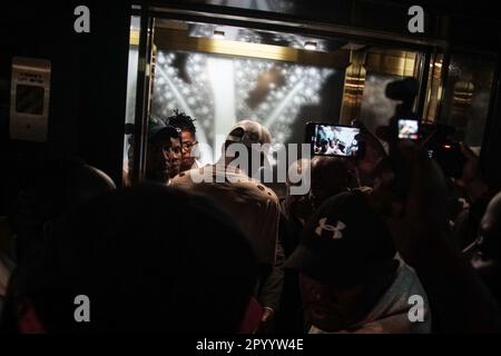 Nakuru, Kenya. 05th May, 2023. Nigerian Musician and songwriter, Joseph Akinwale, known professionally as Joeboy, an Afro-pop and a lift R&B music singer is seen behind other people in the elevator after arriving at his hotel in Nakuru ahead of his performance at The Rift Valley Sports Club on Saturday, May 5, 2023. Credit: SOPA Images Limited/Alamy Live News Stock Photo