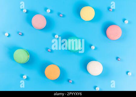 a top view colored french macarons round sweet delicious isolated on the blue background cake confectionery sweet Stock Photo