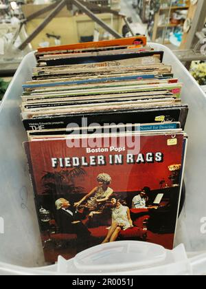 Old vintage vinyl long playing records or LP's, in sleeves in a box in an antique store in Montgomery Alabama, USA. Stock Photo