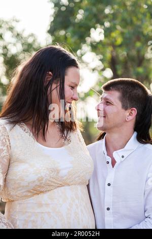 Portrait of a happy couple looking at one another outside in nature Stock Photo