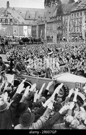 Adolf Hitler drives through the crowd in Eger/Cheb on 3 October 1938 after the annexation of the Sudetenland. After the annexation of Austria, Hitler demanded that he be given the Sudeten region of Czechoslovakia. At the Munich conference in September 1938 the Western powers agreed to this and the nazis occupied the area. Not long after Hitler broke his promise and invaded the rest of Czechoslovakia before turning his attention to Poland. Stock Photo