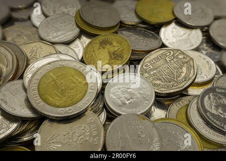 Pile of Thai coins macro close up. Ten, five, two and one Baht. Stock Photo