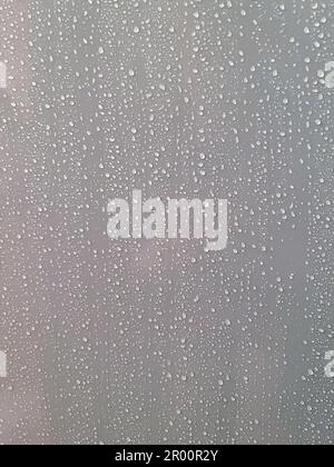 Close up abstract texture background of water droplets on a smooth shower wall surface Stock Photo