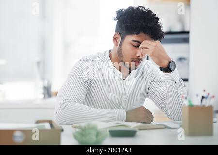 Okay now, calm down, dont panic. a young businessman looking stressed out while working in an office. Stock Photo