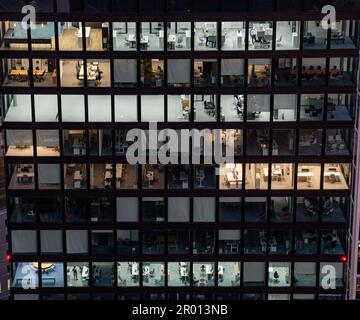 The office building at the late hour in the evening with multiple floors and glass windows in Germany, Europe Stock Photo