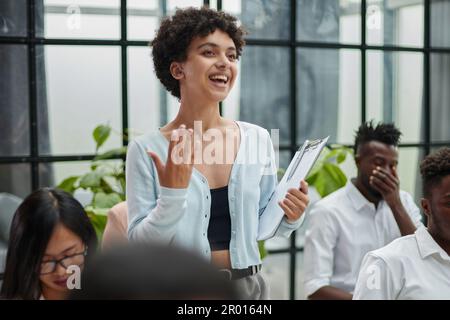 Young woman coach speaker giving flipchart presentation Stock Photo