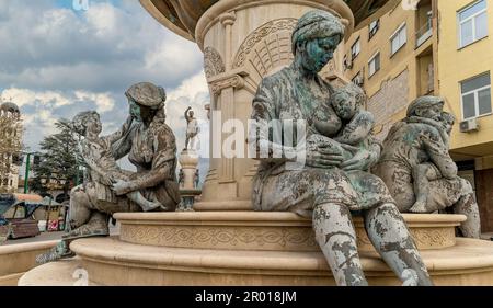 Skopje, North Macedonia.The Mothers of Macedonia Fountain statues with statue of Philip II of Macedon, father of Alexander the Great at behind. Stock Photo