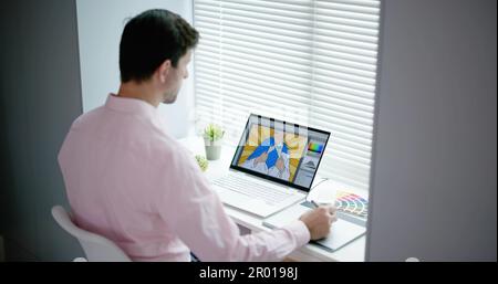 Male Designer Using Graphic Tablet While Working On Computer Stock Photo