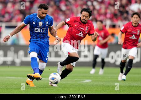 Al Hilal's Ali Al Bulayhi, right, fights for the ball with Urawa