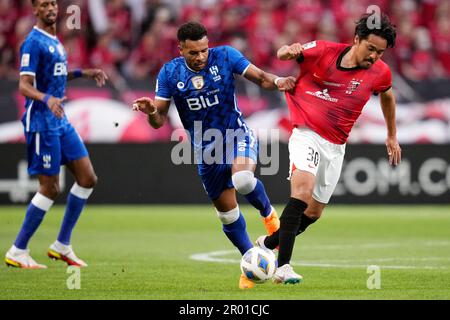 Al Hilal's Ali Al Bulayhi, right, fights for the ball with Urawa