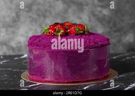 Fruit and chocolate cream cake. Birthday or celebration cake. Strawberry and chocolate cream cake on dark background. Stock Photo