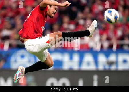 Al Hilal's Ali Al Bulayhi, right, fights for the ball with Urawa