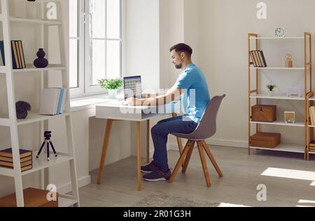 Serious focused businessman or freelancer working with laptop at home office Stock Photo