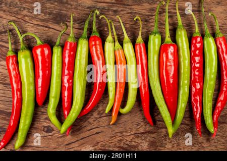 Chilli peppers are widely used in many cuisines as spice to add heat to dishes. Here are some fresh organic green and red chilli forming a background. Stock Photo