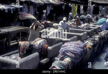 workers at the outdoor Laundry Dhobi Ghat at Mahalaxmi in the city centre of Mumbai in India.  India, Mumbai, March, 1998 Stock Photo