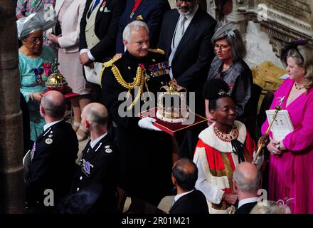 (right to left) Baroness Floella Benjamin, carrying the The Sovereign’s Sceptre with the Dove, General Sir Gordon Messenger, the Governor of HM Tower of London, carrying St Edward’s Crown as Lord High Steward of England, and Dame Elizabeth Anionwu, carrying The Sovereign’s Orb, at the coronation of King Charles III and Queen Camilla at Westminster Abbey, London. Picture date: Saturday May 6, 2023. Stock Photo