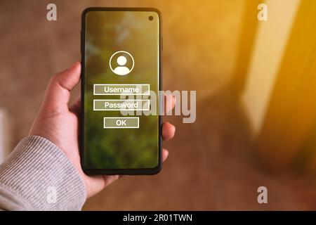 Woman use smartphone to input username and password. Technology security system. Prevent hacker concept. Stock Photo