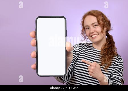 woman showing smartphone with blank white screen Stock Photo