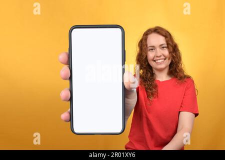woman showing smartphone with blank white screen Stock Photo