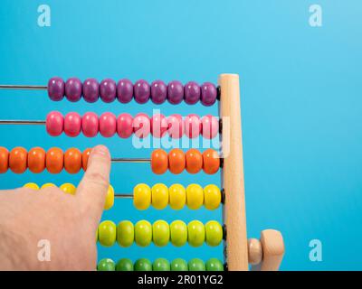 Wooden abacus on a blue background, Wooden abacus for children. Wooden abacus close-up. Stock Photo